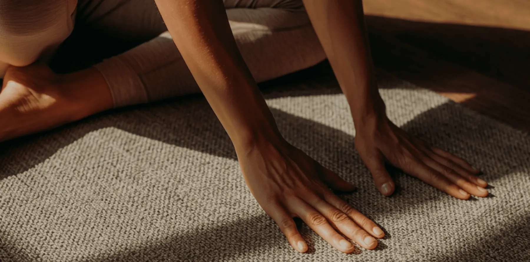 Hands pressed into a woven mat during practice