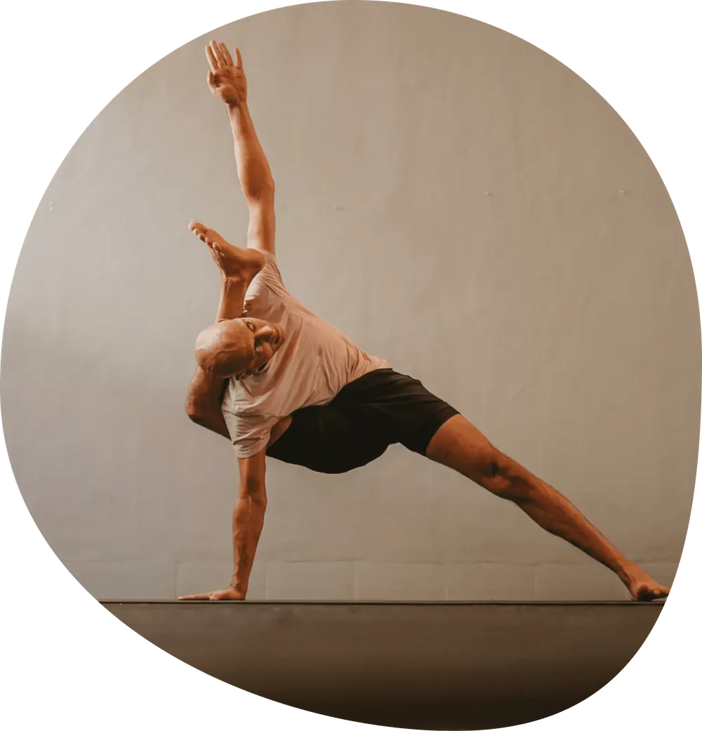 A practitioner holding an extended side-angle twist